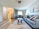 Inviting living room featuring wood-look floors, cozy sofas, and ample natural light at 10525 Mira Vista Dr, Port Richey, FL 34668