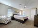 This main bedroom features carpet, 3 windows with blinds and a ceiling fan at 10525 Mira Vista Dr, Port Richey, FL 34668