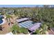 Aerial view of shuffleboard courts surrounded by mature trees near the community lake at 10525 Mira Vista Dr, Port Richey, FL 34668