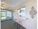 Cozy sunroom with a decorative accent and a pass-through window to another room at 10525 Mira Vista Dr, Port Richey, FL 34668