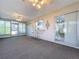 Large sunroom with lots of windows, a ceiling fan, and space for seating or entertaining at 10525 Mira Vista Dr, Port Richey, FL 34668