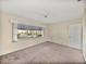 Bedroom featuring neutral walls, carpet, and a large window overlooking the landscaped yard at 1213 60Th S St, Gulfport, FL 33707