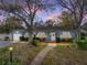 Charming blue home featuring a landscaped front yard and a cozy entryway adorned with a wreath at 1213 60Th S St, Gulfport, FL 33707