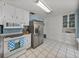 Spacious kitchen featuring stainless steel refrigerator and ample cabinet space at 1213 60Th S St, Gulfport, FL 33707