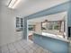 Bright kitchen with a pass-through to sunroom and built-in cabinetry at 1213 60Th S St, Gulfport, FL 33707