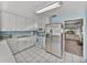 Eat-in kitchen features white cabinets, stainless refrigerator and adjacent dining area at , Gulfport, FL 33707