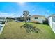 Spacious backyard features a screened porch, well-maintained lawn, and convenient canal access for waterfront living at 13614 Evelane Dr, Hudson, FL 34667