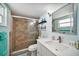 Bathroom featuring a glass enclosed walk-in shower and single sink vanity at 13614 Evelane Dr, Hudson, FL 34667