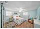 Cozy bedroom with a queen bed, ceiling fan, and lots of natural light from the windows at 13614 Evelane Dr, Hudson, FL 34667