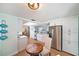 Bright kitchen boasts stainless steel appliances, white cabinetry and adjacent dining area at 13614 Evelane Dr, Hudson, FL 34667