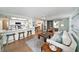 Open floor plan with breakfast bar, living room and dining area featuring coastal decor, tile floors and ample seating at 13614 Evelane Dr, Hudson, FL 34667