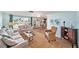 Bright, coastal living room with water views, comfortable seating, and an open floor plan with tile floors at 13614 Evelane Dr, Hudson, FL 34667