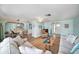 Inviting living room with coastal decor, comfortable seating, open floor plan with arched doorways and tile floors at 13614 Evelane Dr, Hudson, FL 34667