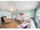 Comfortable coastal living room with neutral colors, cozy seating, large windows and an open floor plan at 13614 Evelane Dr, Hudson, FL 34667