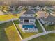 Aerial view of a home with a large backyard pool, patio, fenced yard and neighborhood at 14477 Trails Edge Blvd, Odessa, FL 33556