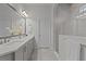 Bright bathroom featuring double sinks, herringbone tile floor, and glass enclosed shower at 14477 Trails Edge Blvd, Odessa, FL 33556