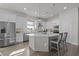 Well-lit kitchen featuring white cabinetry, stainless steel appliances and a large center island at 14477 Trails Edge Blvd, Odessa, FL 33556