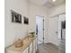 Hallway featuring light wood floors and a view into another room, with two art prints on the wall at 14541 Mirabelle Vista Cir, Tampa, FL 33626