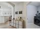 Hallway view with light wood floors and a laundry room, featuring a modern front-load washer at 14541 Mirabelle Vista Cir, Tampa, FL 33626