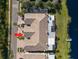 Overhead aerial view of the property showcasing the exterior and access to the lake at 1576 Lago Vista Blvd, Palm Harbor, FL 34685