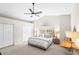 Bright bedroom with a ceiling fan, neutral carpet, and soft, natural lighting at 1576 Lago Vista Blvd, Palm Harbor, FL 34685