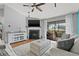 Bright living room with ceiling fan, fireplace, and sliding glass doors to balcony at 2085 Hunters Glen Dr # 228, Dunedin, FL 34698