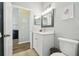 Bright bathroom features a white vanity, modern fixtures, and a pristine toilet at 2509 Estancia Blvd, Clearwater, FL 33761