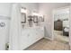 Bathroom showcasing a double vanity with white cabinets and a walk-in shower at 2509 Estancia Blvd, Clearwater, FL 33761