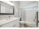 Clean bathroom featuring a tub with shower, white vanity with lots of counter space, and updated fixtures at 2509 Estancia Blvd, Clearwater, FL 33761