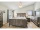 Bedroom with wood-look tile flooring, a vaulted ceiling, and a large wooden bed set at 2509 Estancia Blvd, Clearwater, FL 33761