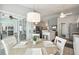 Bright dining area with a round wooden table and white chairs, situated near sliding glass doors and the kitchen at 2509 Estancia Blvd, Clearwater, FL 33761