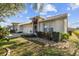 Inviting single-story home features a well-manicured lawn, two car garage, and neutral exterior paint at 2509 Estancia Blvd, Clearwater, FL 33761