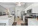 Bright and open kitchen featuring stainless appliances, tile floor, and white cabinets at 2509 Estancia Blvd, Clearwater, FL 33761