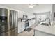Clean kitchen offering white cabinets, stainless appliances, and an eat-in breakfast nook at 2509 Estancia Blvd, Clearwater, FL 33761