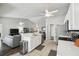 Spacious kitchen with stainless appliances, breakfast bar, and open floorplan to living area at 2509 Estancia Blvd, Clearwater, FL 33761