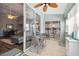 Enclosed lanai with ceiling fan and dining set features sliding glass doors to living room at 2509 Estancia Blvd, Clearwater, FL 33761
