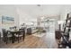 Open-concept living room with dining area, kitchen, and sliding glass doors to a screened patio at 2509 Estancia Blvd, Clearwater, FL 33761