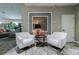 Elegant lobby area featuring two white chairs, a stylish table, and a decorative wall accent at 2509 Estancia Blvd, Clearwater, FL 33761