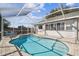 Screened-in pool features a brick paver deck, steps and a partial fence at 2509 Estancia Blvd, Clearwater, FL 33761