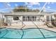 Screened-in pool featuring a brick paver deck and access to the back of the home at 2509 Estancia Blvd, Clearwater, FL 33761