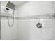 Walk-in shower with white subway tile and a shower head at 2509 Estancia Blvd, Clearwater, FL 33761