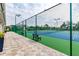 View of tennis courts surrounded by fencing, with benches for resting between matches at 2509 Estancia Blvd, Clearwater, FL 33761