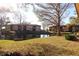 Scenic backyard featuring a serene pond and lush greenery, with a community building visible in the background at 2689 Sabal Springs Cir # 103, Clearwater, FL 33761