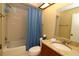 This full bathroom features a shower/tub combo, and a granite sink at 2689 Sabal Springs Cir # 103, Clearwater, FL 33761