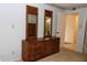 Bright bedroom shows a dark wood dresser with two decoratively framed mirrors above at 2689 Sabal Springs Cir # 103, Clearwater, FL 33761