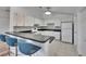 Bright kitchen features white cabinetry, a modern backsplash, and breakfast bar with seating at 2723 W Arch St, Tampa, FL 33607