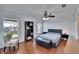 Spacious main bedroom features wood floors, ceiling fan, and a window with a view at 2723 W Arch St, Tampa, FL 33607