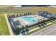 Community pool area featuring manicured grounds, shaded seating, and ample space for relaxation and recreation at 28784 Rambutan Dr, Wesley Chapel, FL 33543