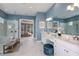 Modern bathroom with double vanities, a large glass shower with rainfall shower head, and marble floors at 29924 Rusco Ct, Wesley Chapel, FL 33545