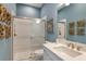 Bathroom featuring walk-in shower with glass door, white tile, and modern vanity at 29924 Rusco Ct, Wesley Chapel, FL 33545